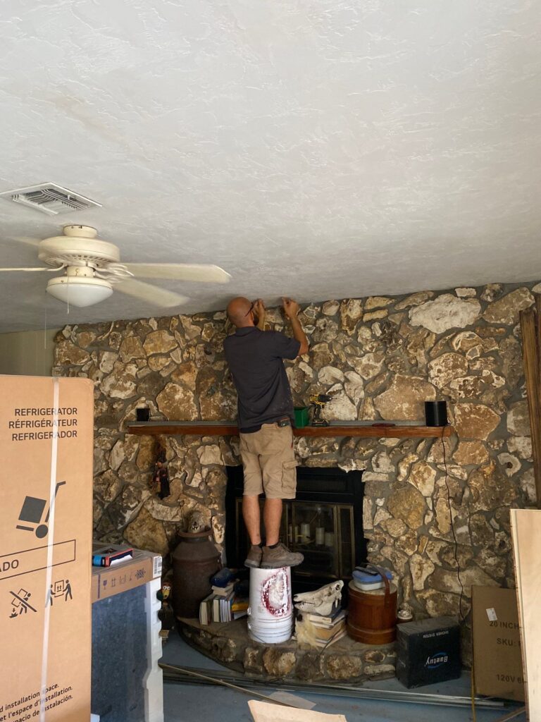 contractor inspecting water-stained ceiling before drywall repair ocala project