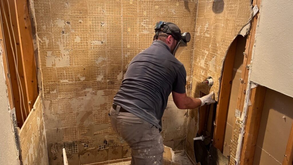 handyman repairing tile grout as part of thornton handyman services