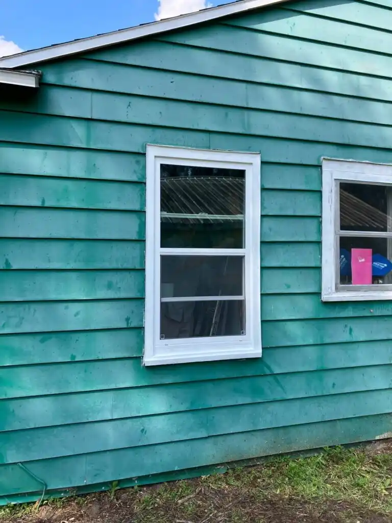 contractor inspecting exterior home repair siding damage on a Marion County house