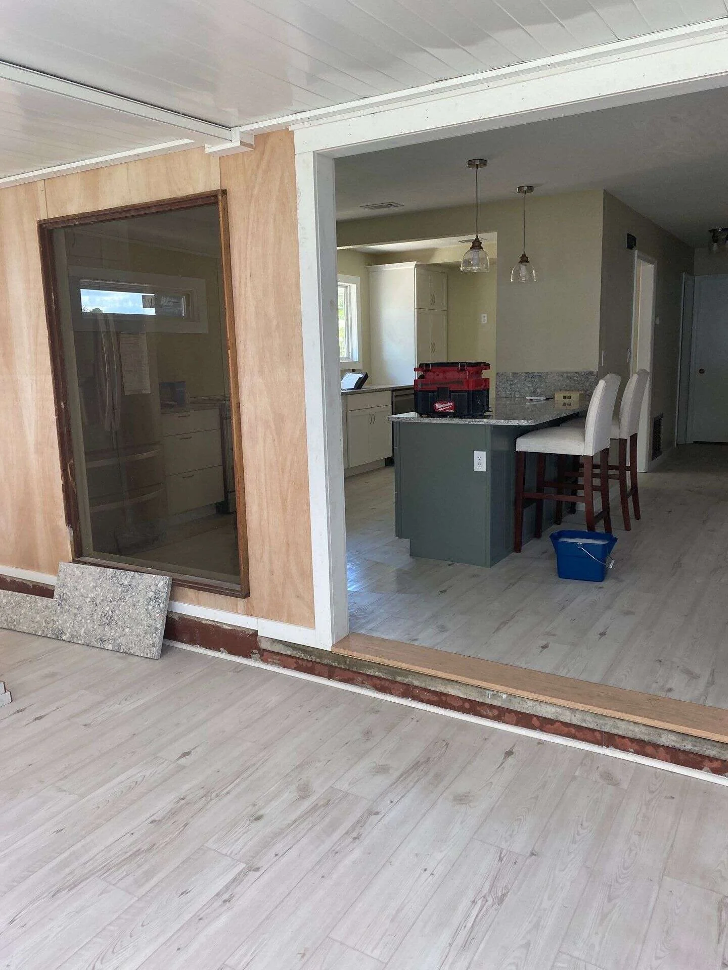 contractor measuring cabinets during kitchen remodeling Dunnellon FL consultation